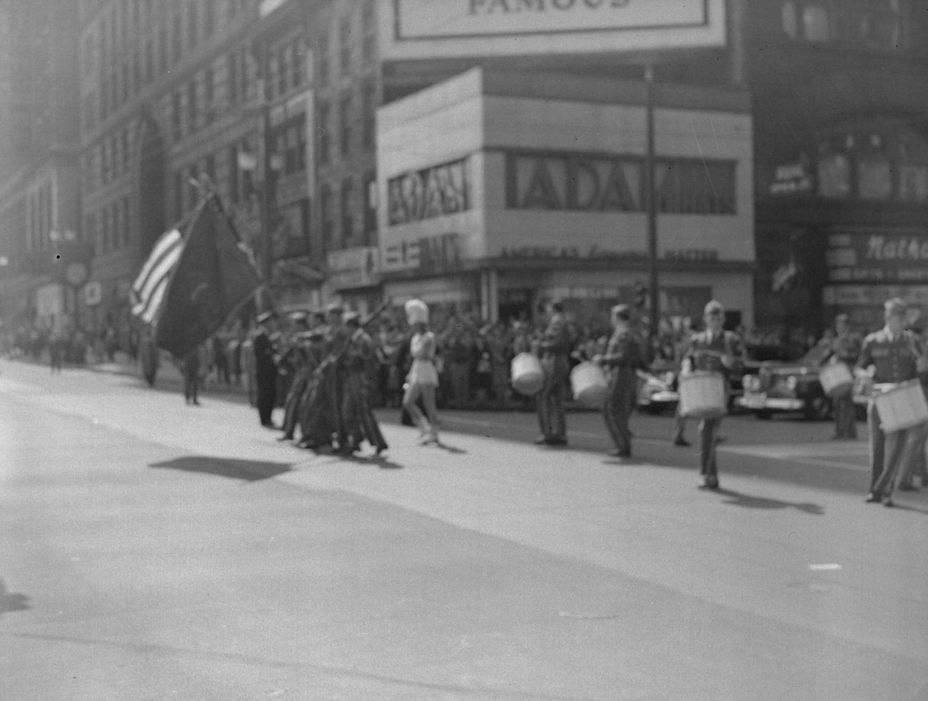 AmVets Post No 8 band marching downtown, featuring Adam Hat Store and Nathan's Gift Shop, 1948.
