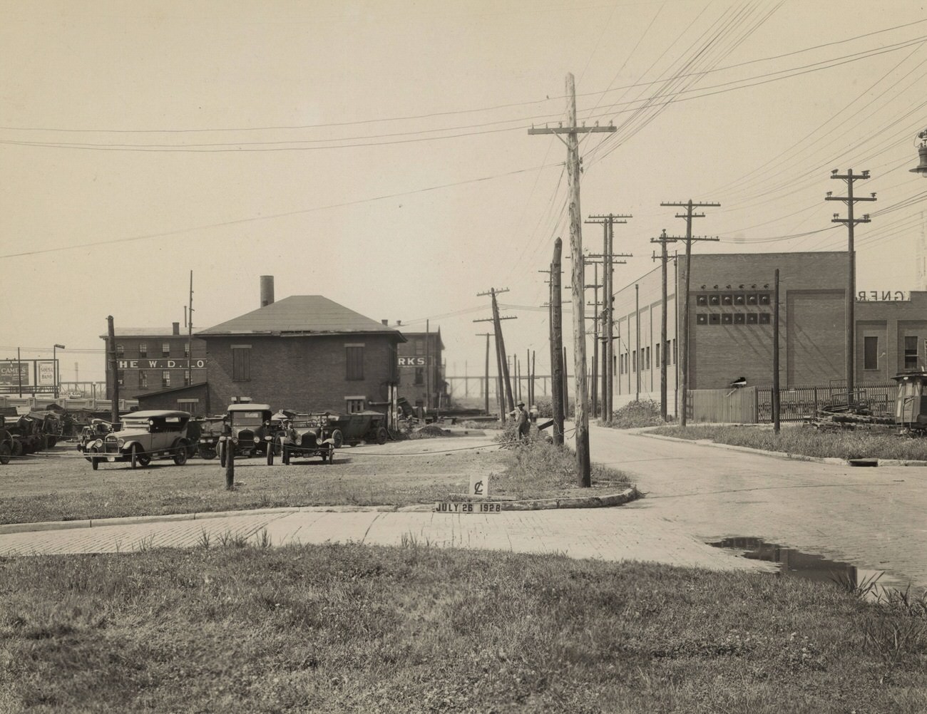 City garage south of Mound Street and west of Short Street, featuring W. D. Lowe Machine & Engine Works and Wagner Awning Company, July 26, 1928.