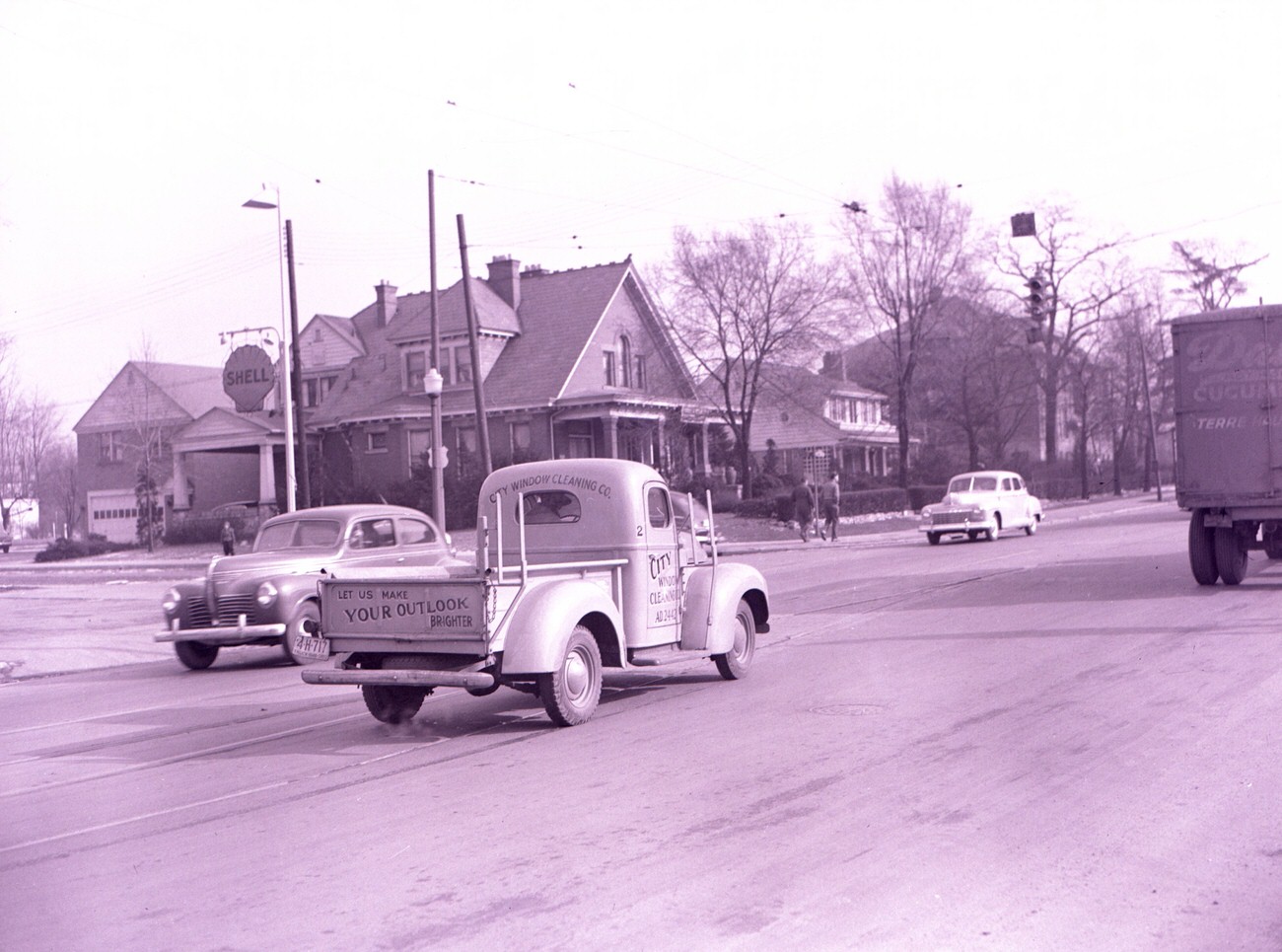 City Window Cleaning Company Truck on East Main Street in Bexley, passing notable buildings including Hatch's Shell Service and Moody & Straley Funeral Home, 1946.