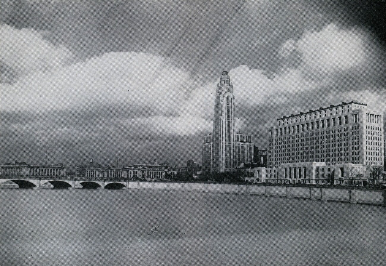 Columbus Civic Center, view looking east across Scioto River featuring Federal Building, City Hall, A.I.U. Citadel (LeVeque Tower), and Ohio Departments of State Building, 1945.