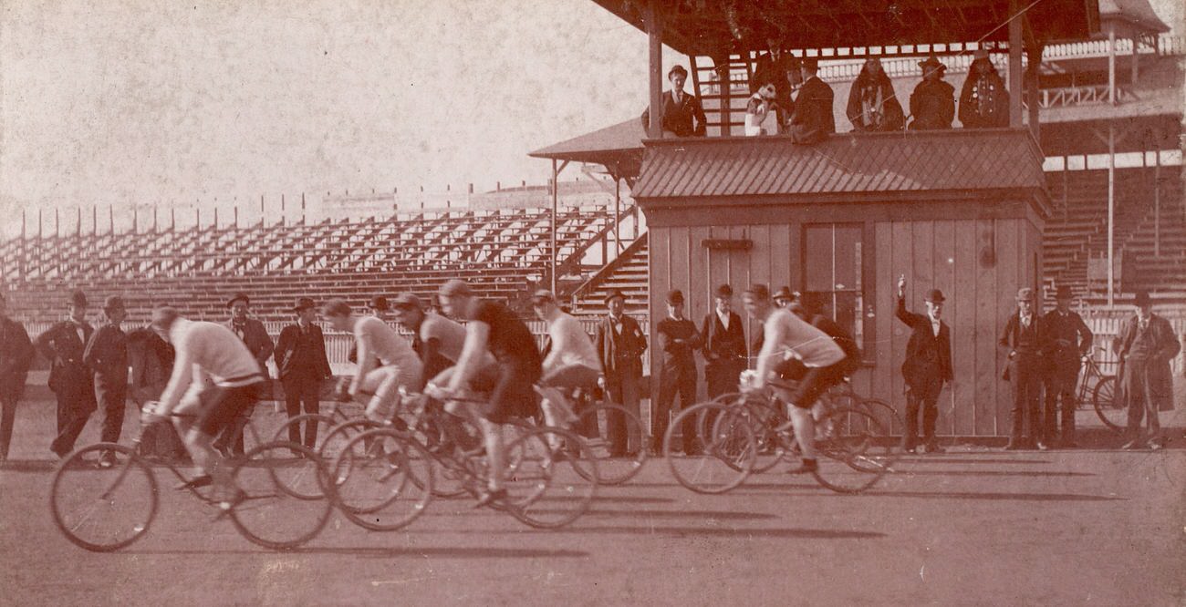 Conn Baker, second rider from the left in white, in a bicycle race in Independence, Iowa, circa 1900.