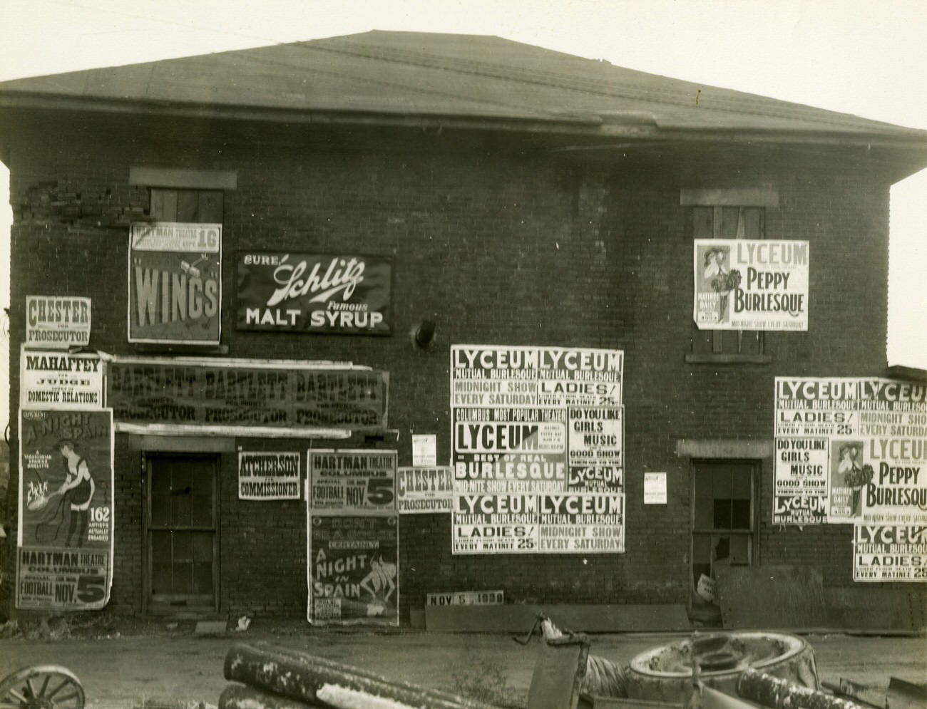 Derelict building covered with burlesque theater ads, part of Olentagy-Scioto sewer project, November 5, 1939.