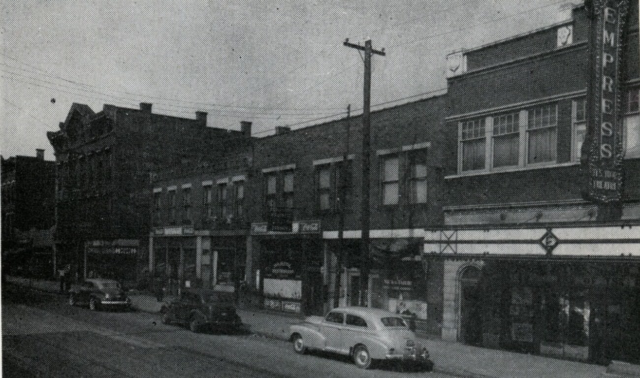 Bronzeville scenes at Long and Garfield, featuring Empress Theatre and other businesses, 1945.