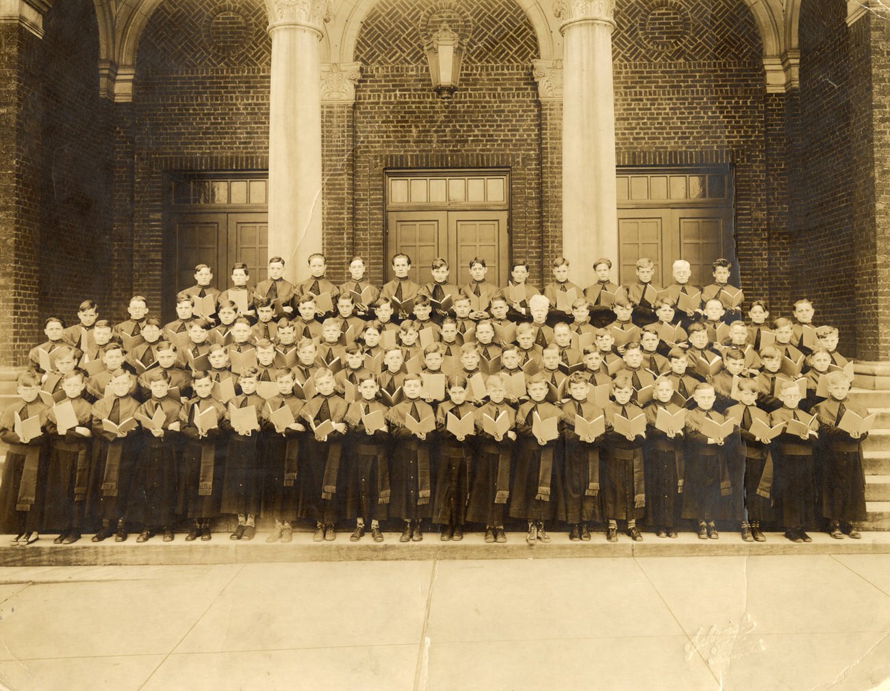 Young boys in church garb on the front steps of Holy Rosary Church, Columbus, 1930s