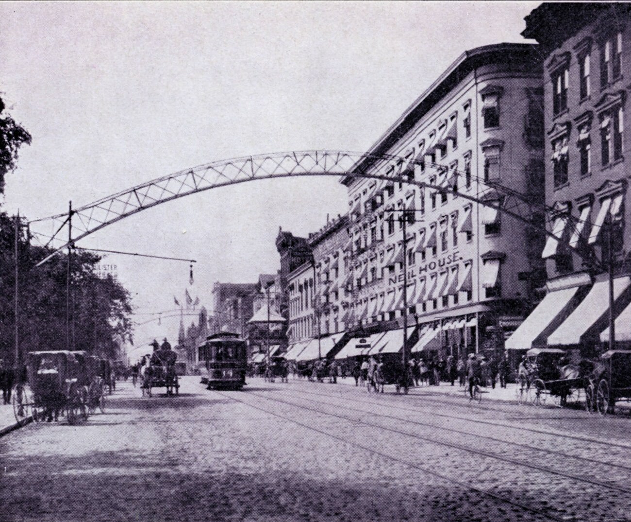 South High Street between Broad and State Streets, with horse-drawn buggies and a streetcar, 1900.