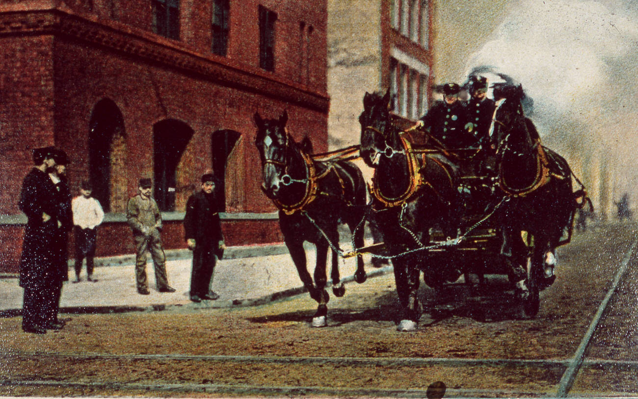 Horse-drawn fire engine in action, 1890s