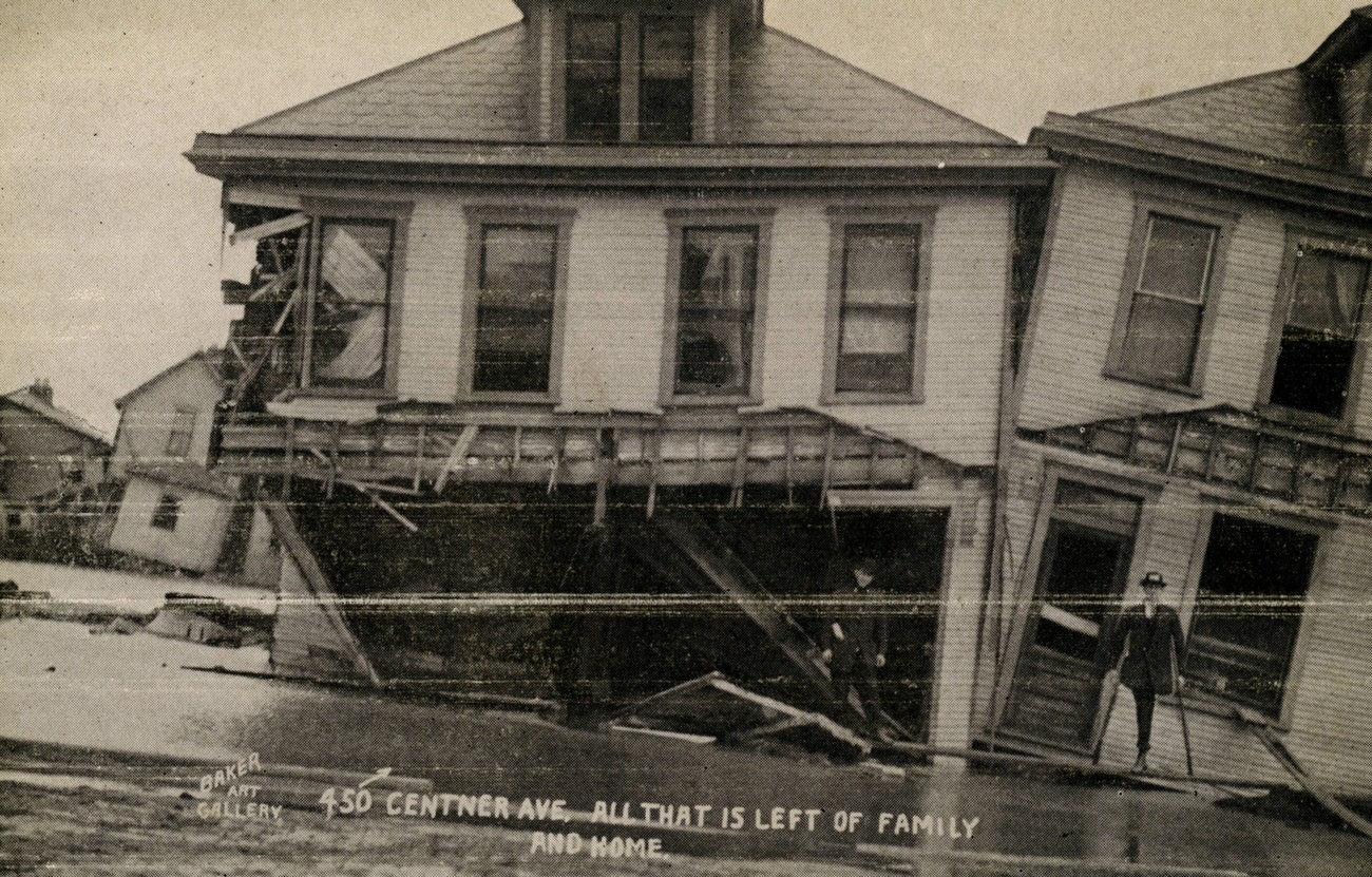 Man in front of destroyed homes on Centner Avenue, showcasing flood's destructive force, 1913.