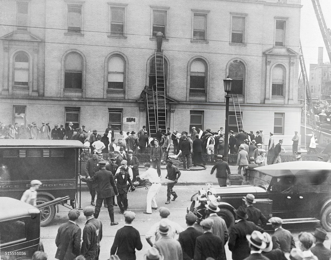 Rescue workers retrieving victims of the Columbus, Ohio prison fire, where over three hundred convicts died, bodies loaded onto Army trucks for transport to a temporary morgue