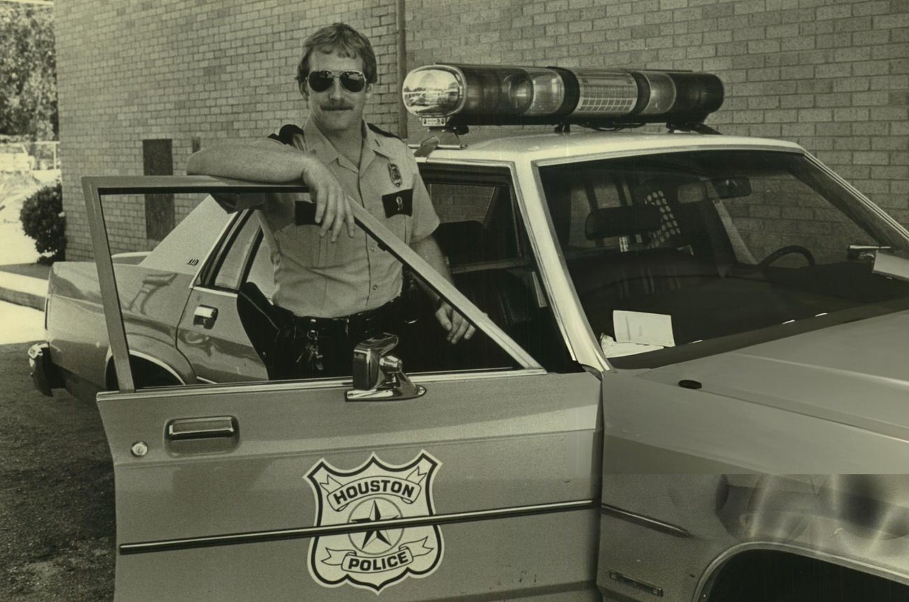Houston police officer T.J. Boyle aids motorists in trouble, Houston, Texas.