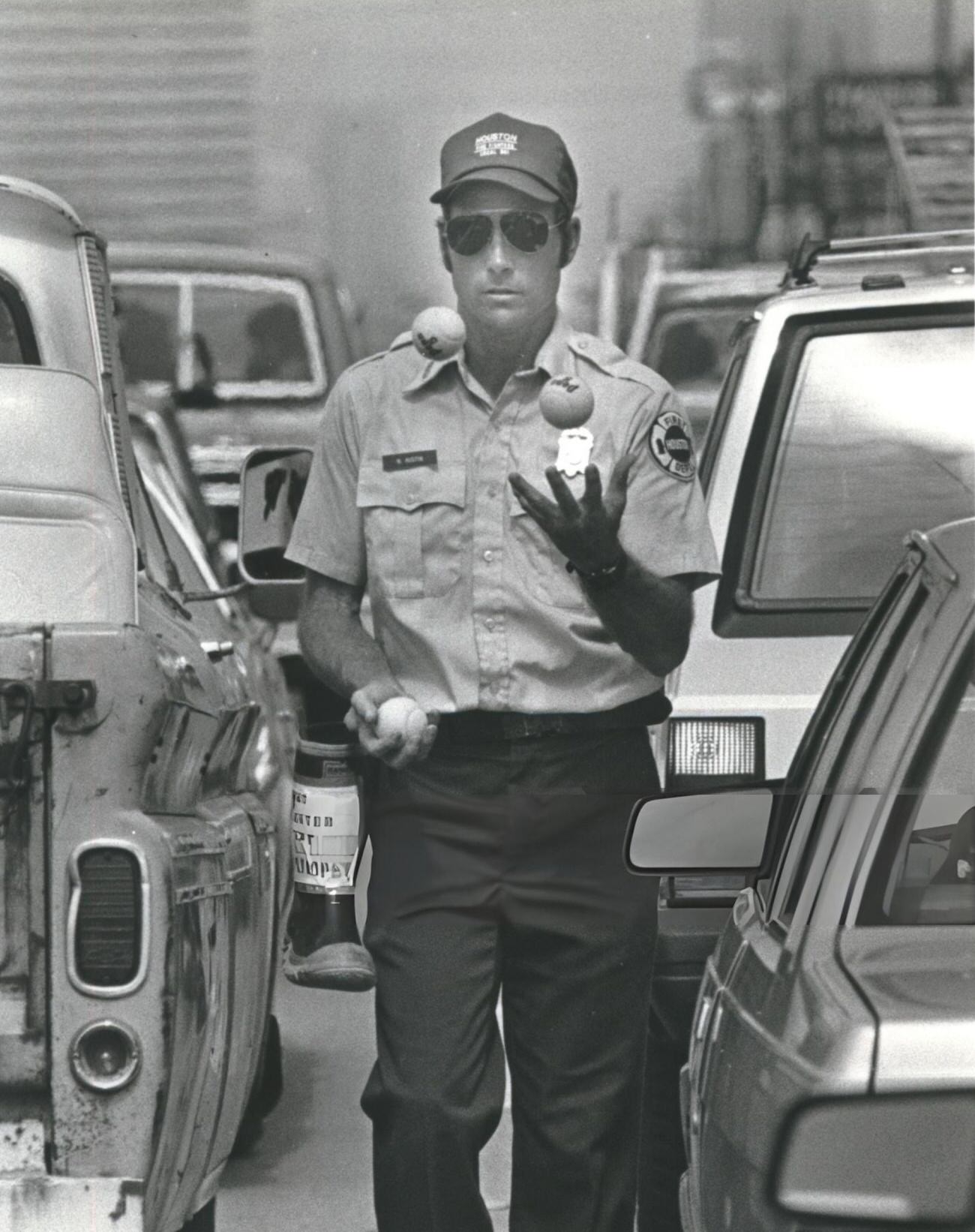 Neal Austin of Fire Station 28 A shift juggles at Westheimer and Hillcroft while collecting for muscular dystrophy, Houston, Texas.