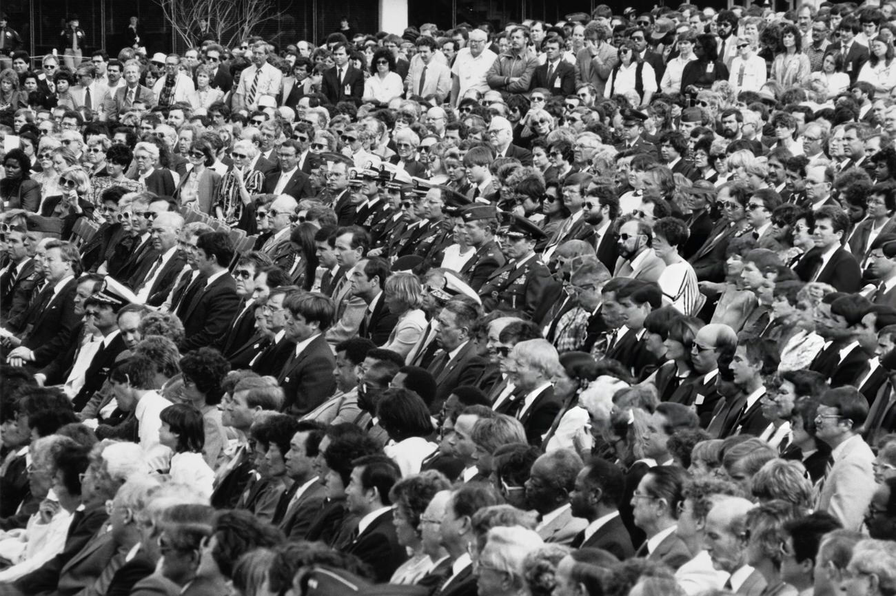 Mourners attend the memorial service for the Space Shuttle Challenger crew at Johnson Space Center, Houston, Texas, 1986.