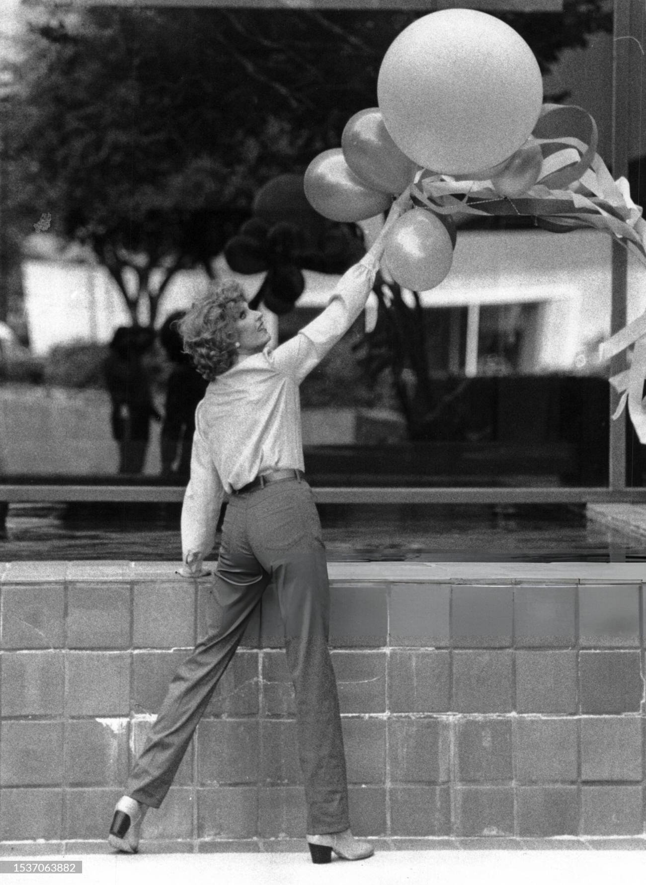 Houston model Dallas Hill models designer Charlotte Ford's burgundy jeans and top from Saks Fifth Avenue, 1981.