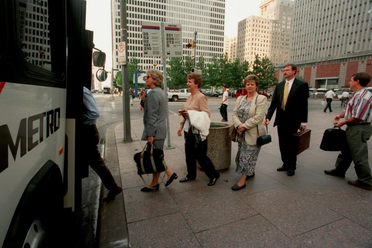 Commuters board a Metro bus on Louisiana Street, reflecting Metro's increased passenger trips, Houston, Texas, 1998.