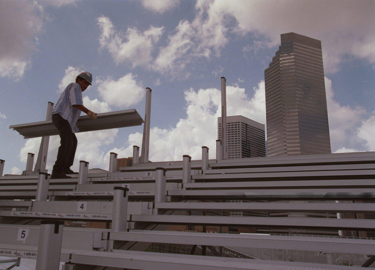 Jaime DelaFuente dismantles scaffolding from the Texaco Grand Prix at the George R. Brown Convention Center, Houston, Texas, 1998.