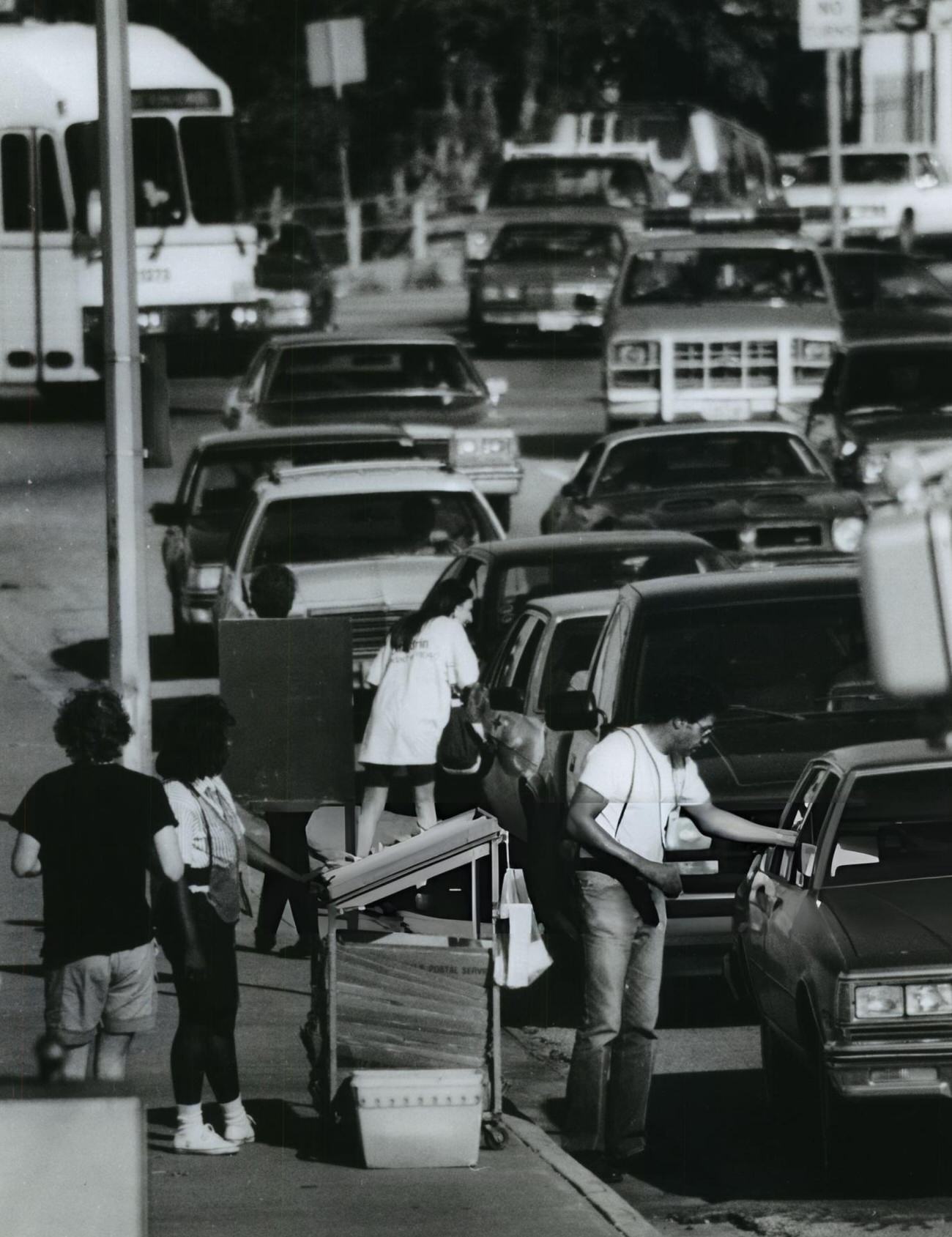 Post Office employees efficiently collect IRS Forms from motorists, a snapshot of pre-digital tax filing, Houston, Texas.