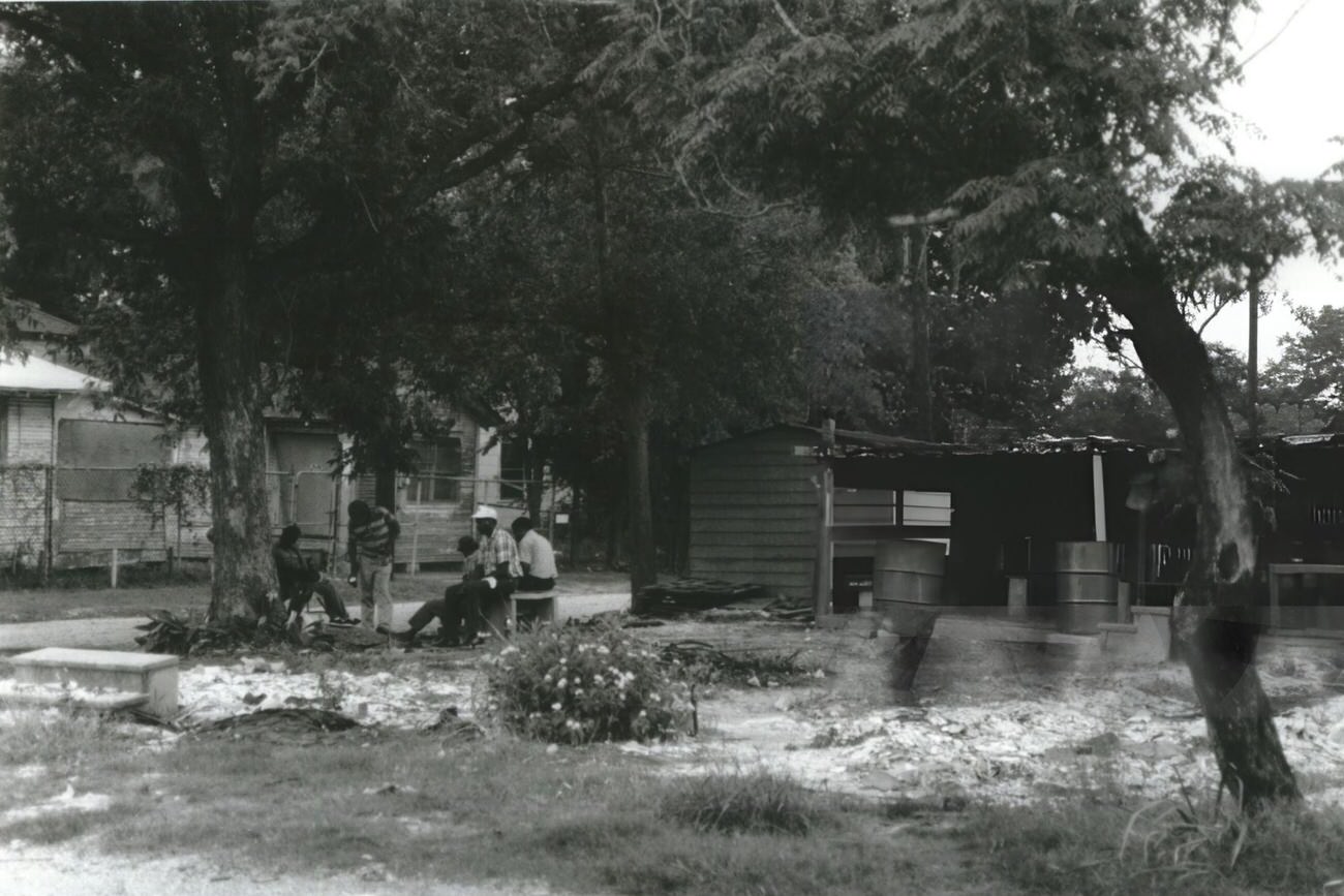 Residents of Jensen & Hill neighborhoods spend a communal afternoon at a local lot, showcasing community life, Houston, Texas.