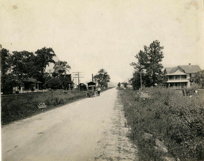 Unimproved road with man and automobile, 1913.