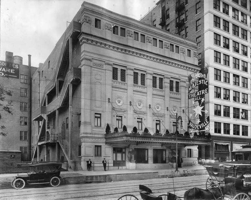 Street view of Majestic Theatre, Houston, with streetcar tracks and horse-drawn carriages, 1910.