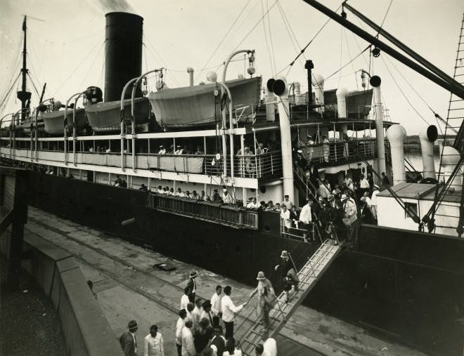 People disembarking from a passenger liner, 1890s