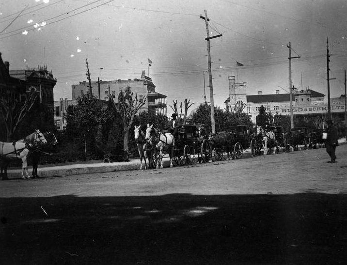View of Alamo Plaza with carriages, 1896.
