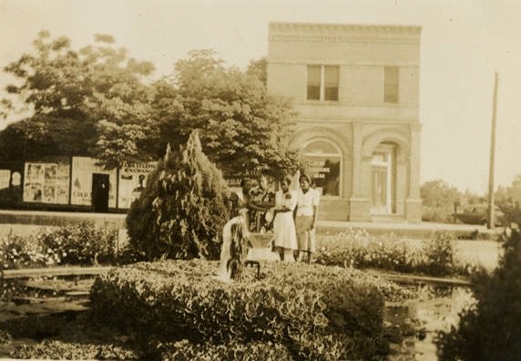 Unidentified women at a garden fountain, 1930s.