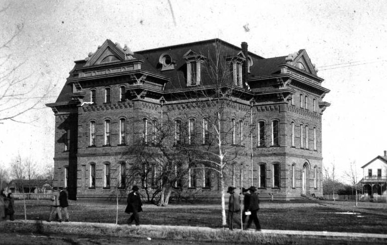 High School in Sherman with people on sidewalk, 1895