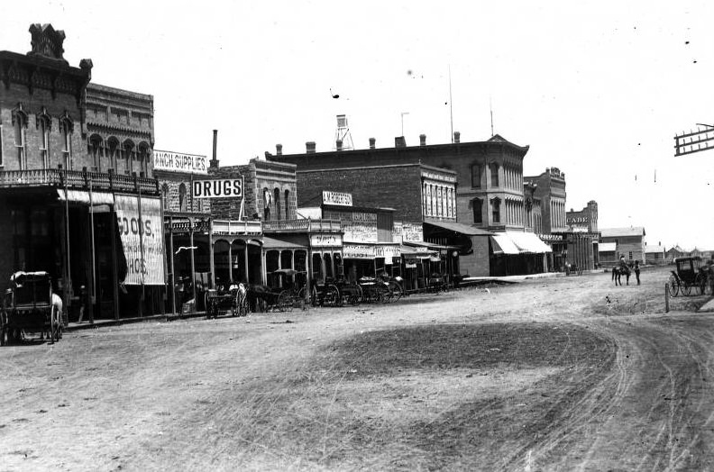 Street scene in Abilene with horse-drawn carriages, 1897