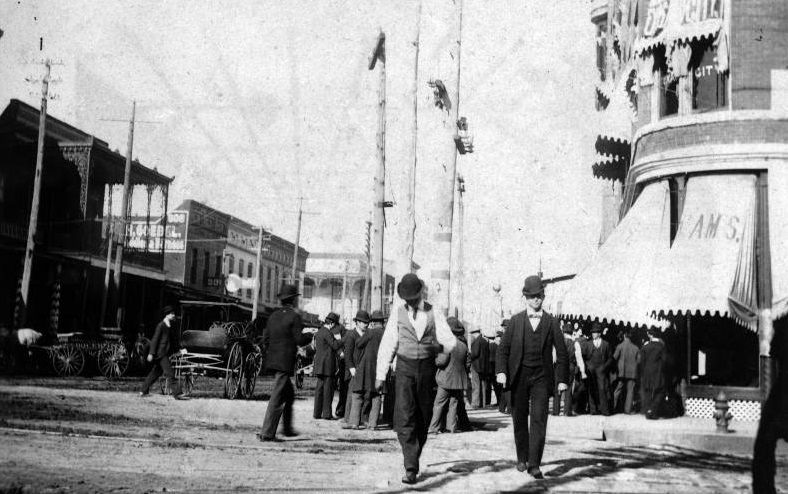 Street view towards a group of men, 1897