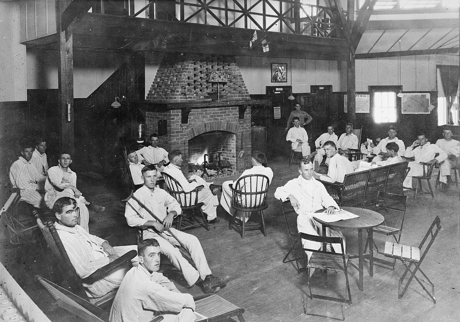 Group gathered around a fireplace in the convalescent building at Camp Logan, Houston, Texas, 1920