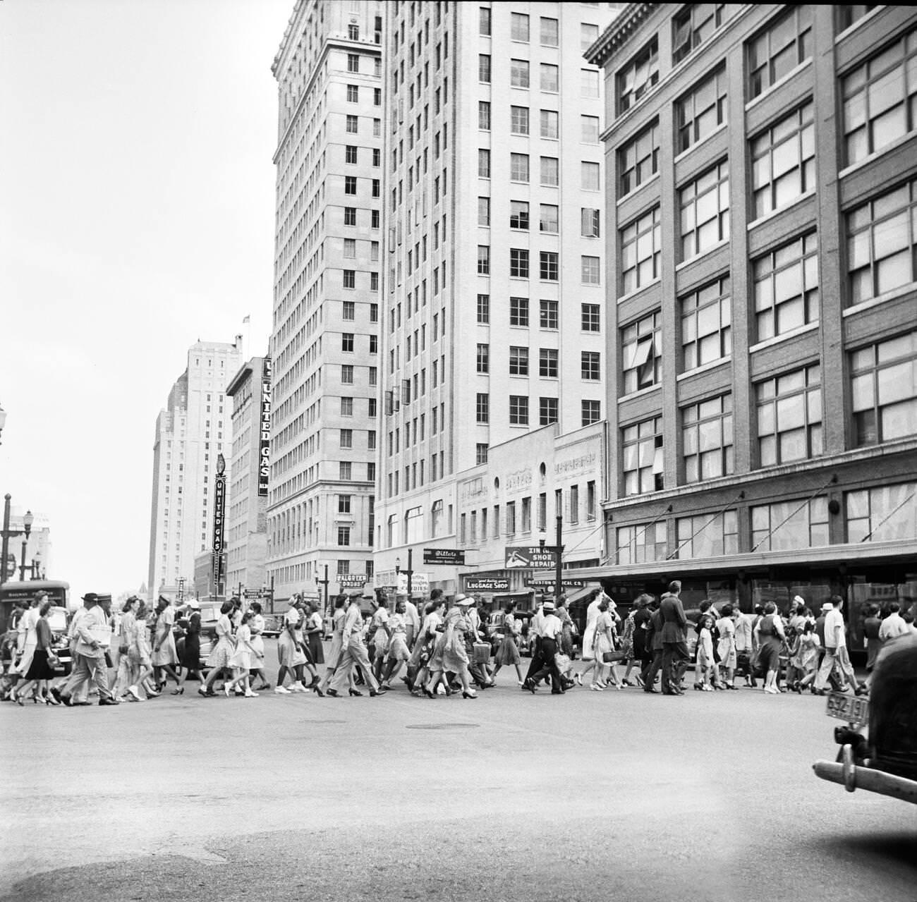 Crowd of pedestrians on a downtown street in Houston, Texas, 1943.