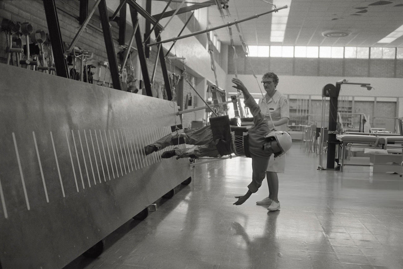 An astronaut simulating a walk at Johnson Space Center, the control and training center for human spaceflight.