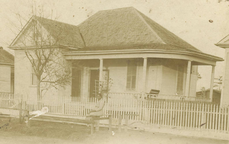 Mrs. Johnson outside her property, Houston, 1910.