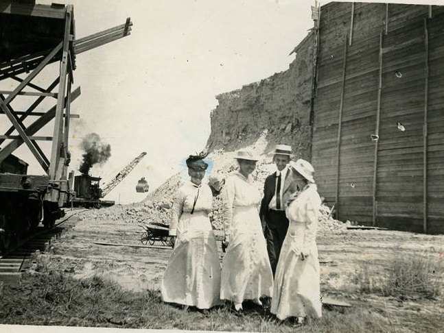 Sulphur plant scene with people and excavator, 1900s