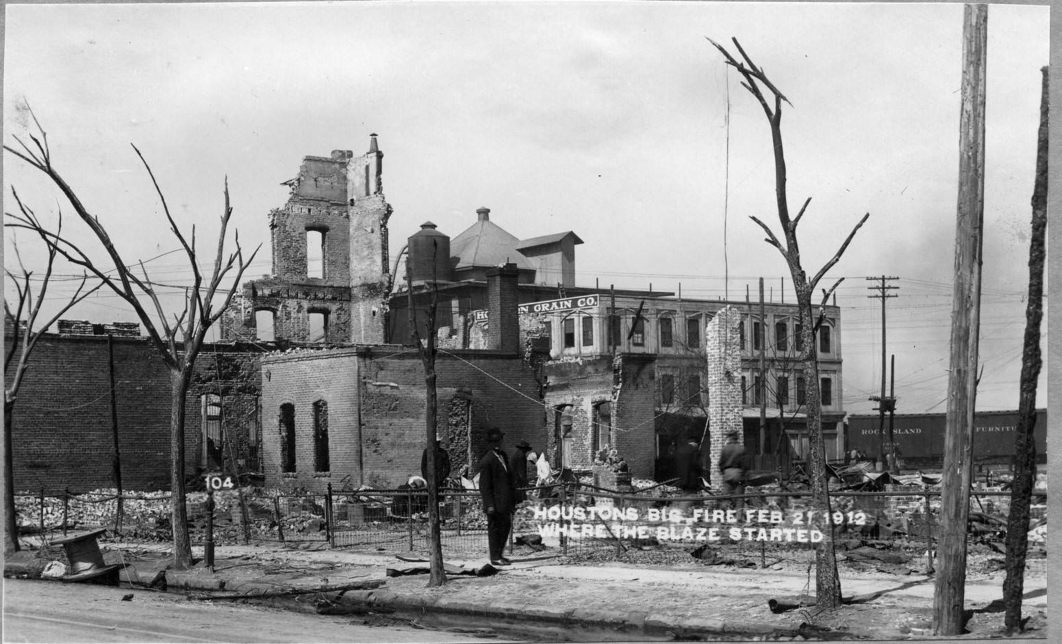 People inspecting fire damage, February 21, 1912.