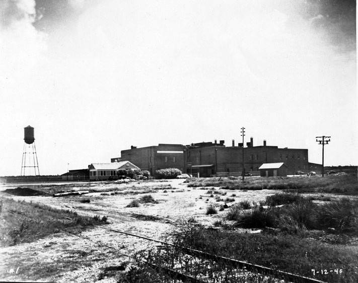 Water tower beside unidentified commercial building, 1945.