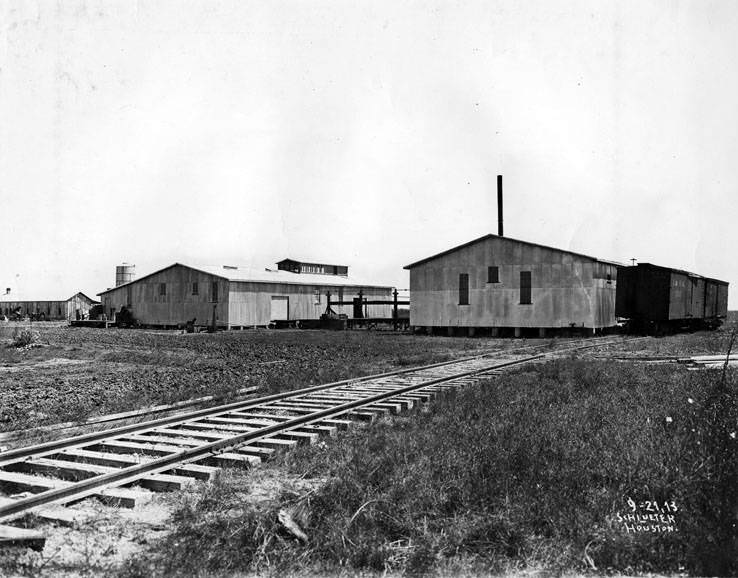 Buildings among railroad tracks, 1923.