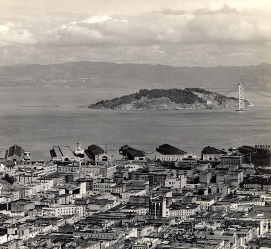 View of the piers, Yerba Buena Island, and the Bay Bridge under construction in the 1930s