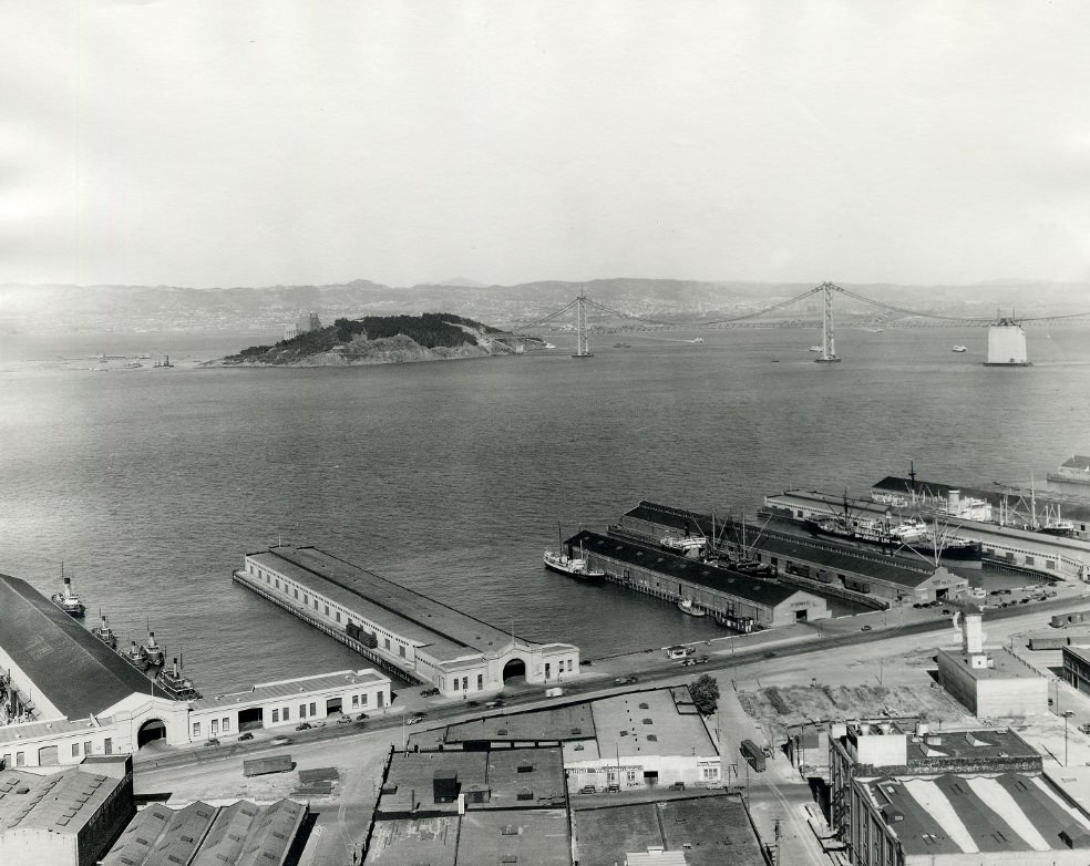 Piers 21 through 17 with the Bay Bridge under construction in the background in the 1930s