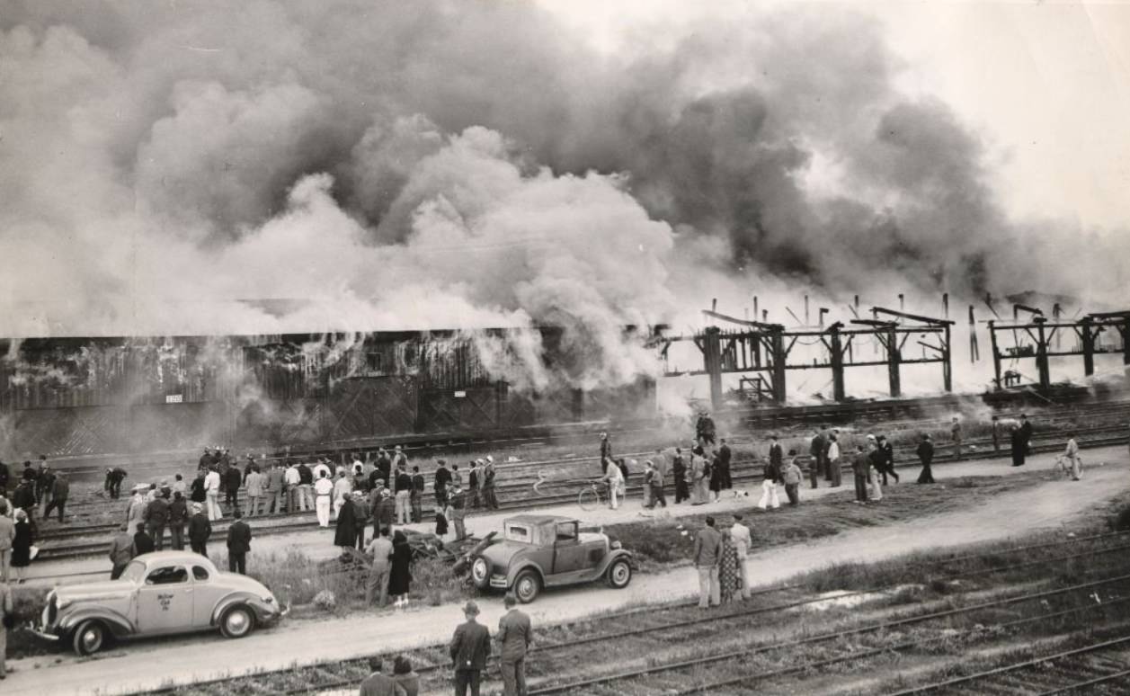 Spectators in front of a freight transfer shed fire on 3rd Street, 1938