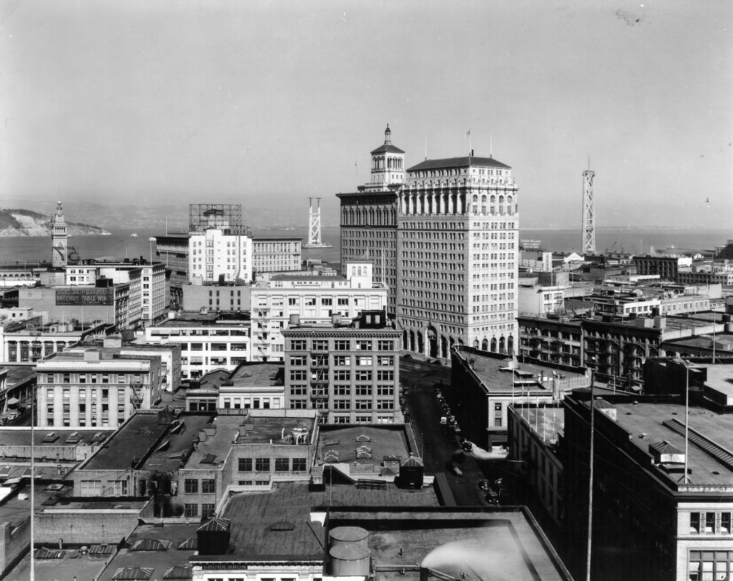 View of San Francisco and Bay Bridge towers under construction, 1934