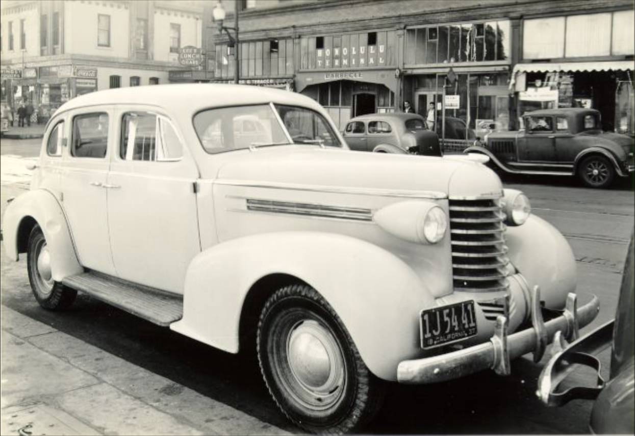 Closeup of a 1937 Oldsmobile parked on Kearny Street near Jackson, 1937