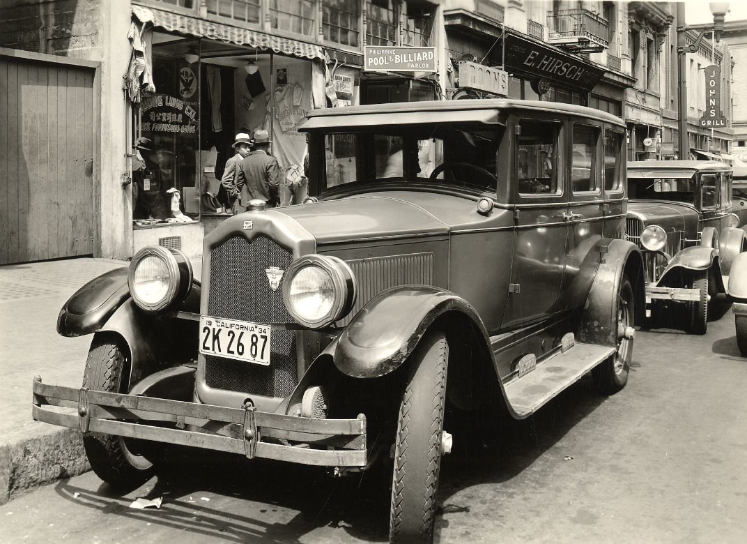 Closeup of car parked on Kearny Street between Washington and Jackson streets, 1934