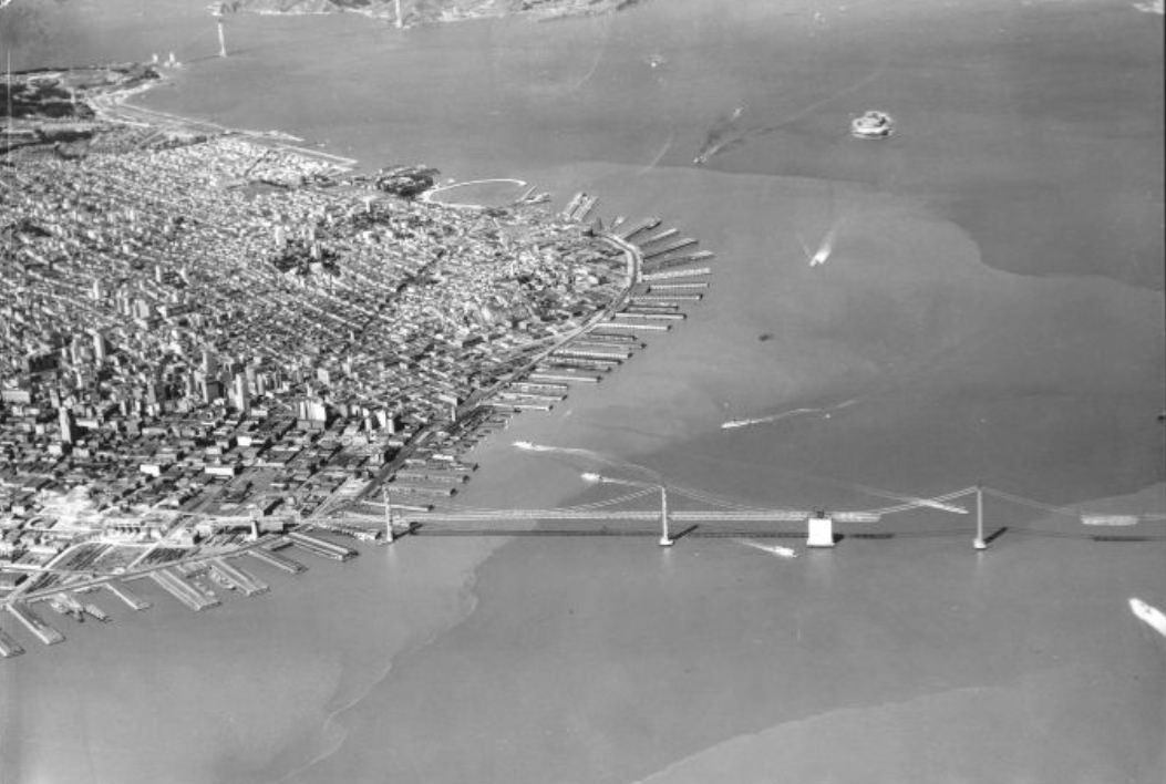 Aerial view of the waterfront during construction on the Bay Bridge, 1930s