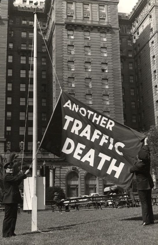 Officers Ed Connell and Frank Dunphy raise the "another traffic death" flag in Union Square, 1939