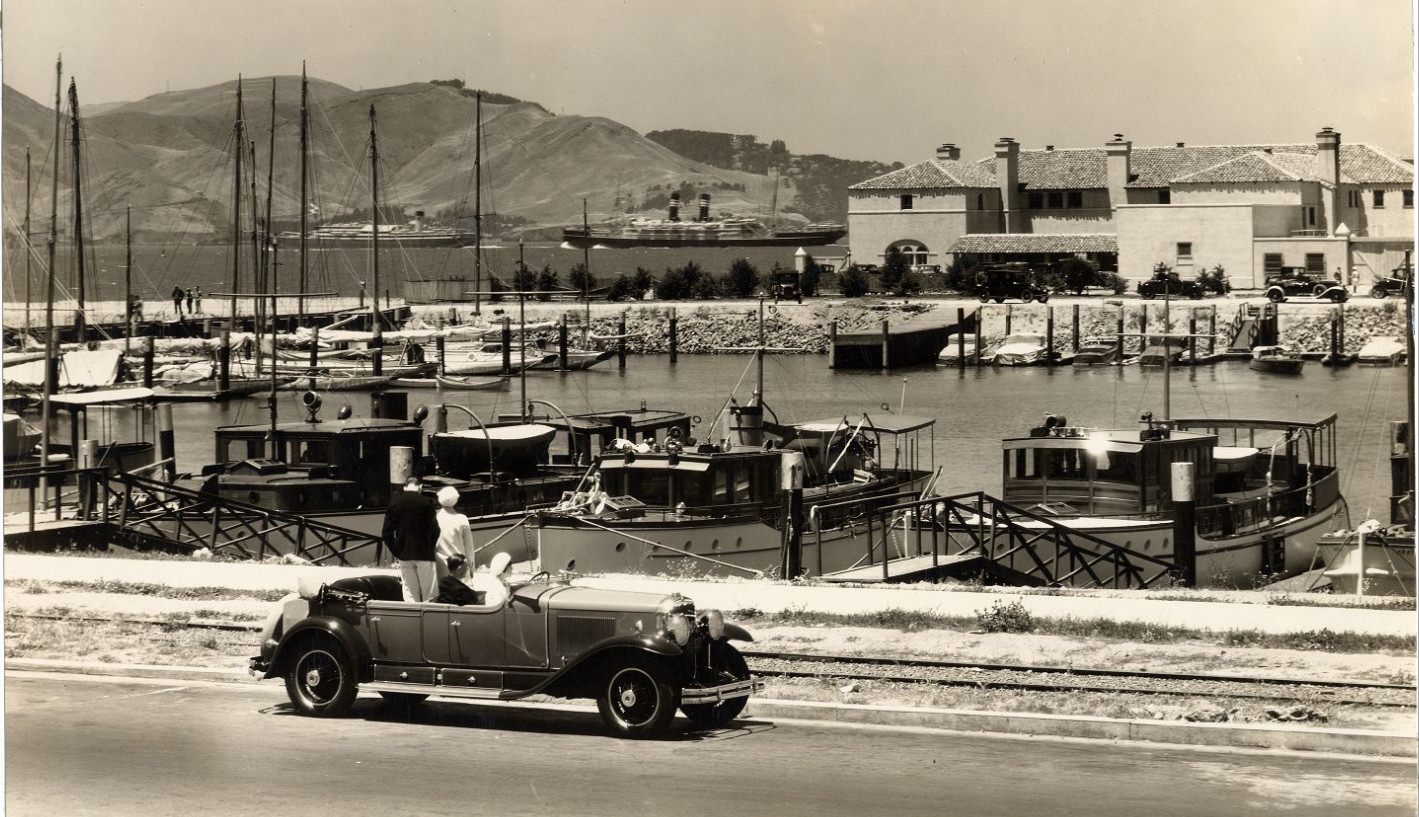Four people in a parked car at Marina Yacht Harbor between 1920 and 1939