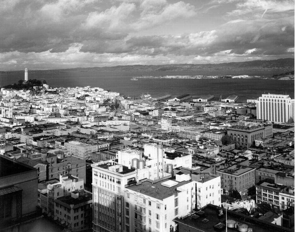 View of downtown San Francisco with Coit Tower on the left and Treasure Island in the distance, 1953.