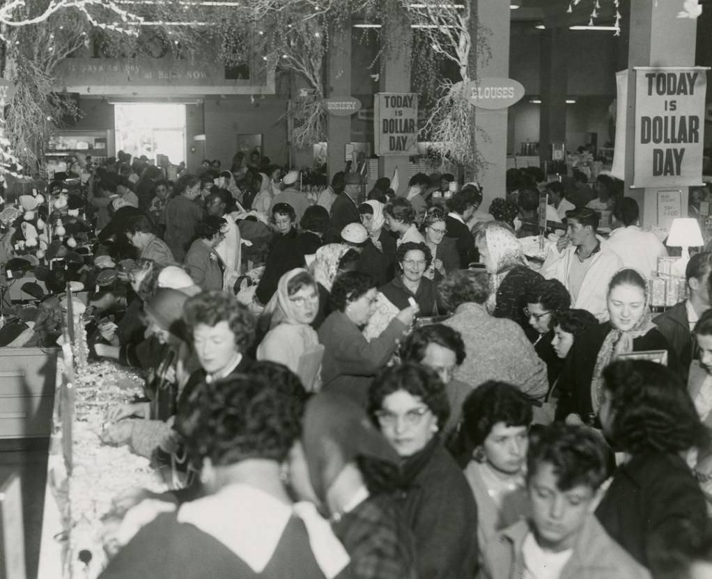 Crowd inside a store on Mission Street for "Dollar Day," 1958.