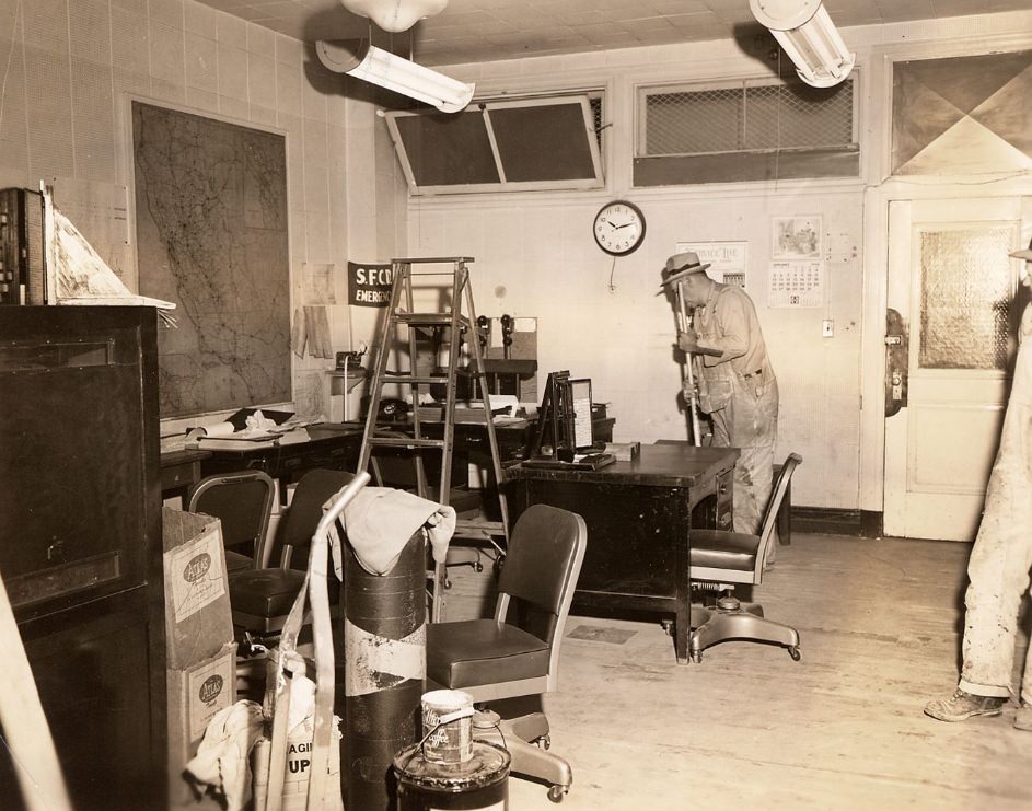Janitors cleaning a small office in the Old Hall of Justice, 1958.