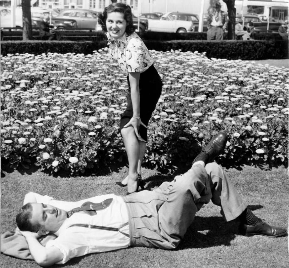 Ameila Balian near sleeping Baron Muller on Civic Center Plaza lawn, 1951.