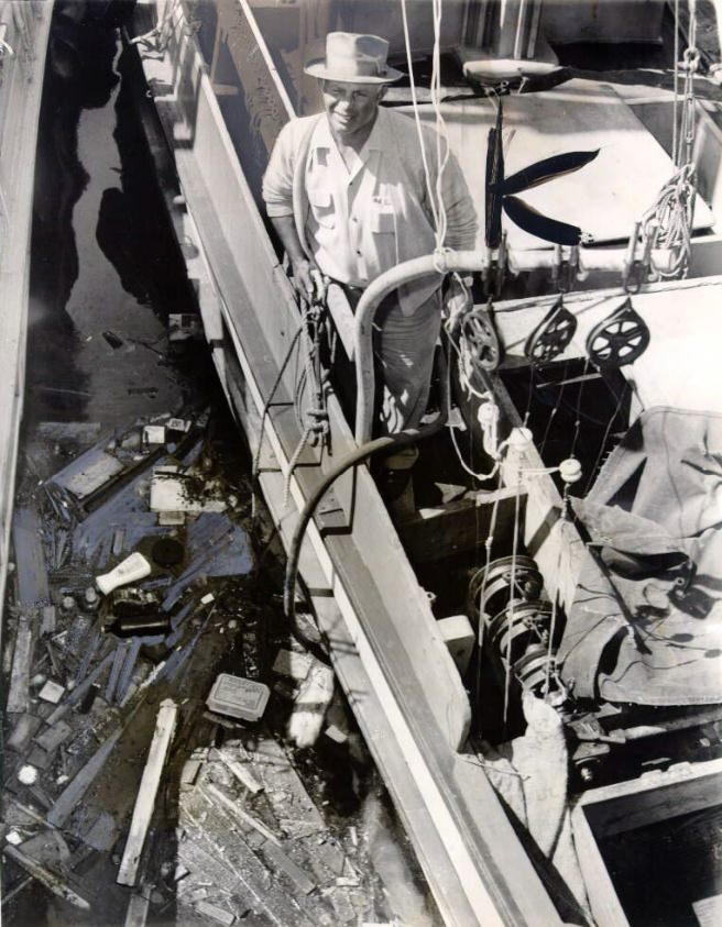 Vincent Spadaro looking at swirling debris in the bay, 1960.